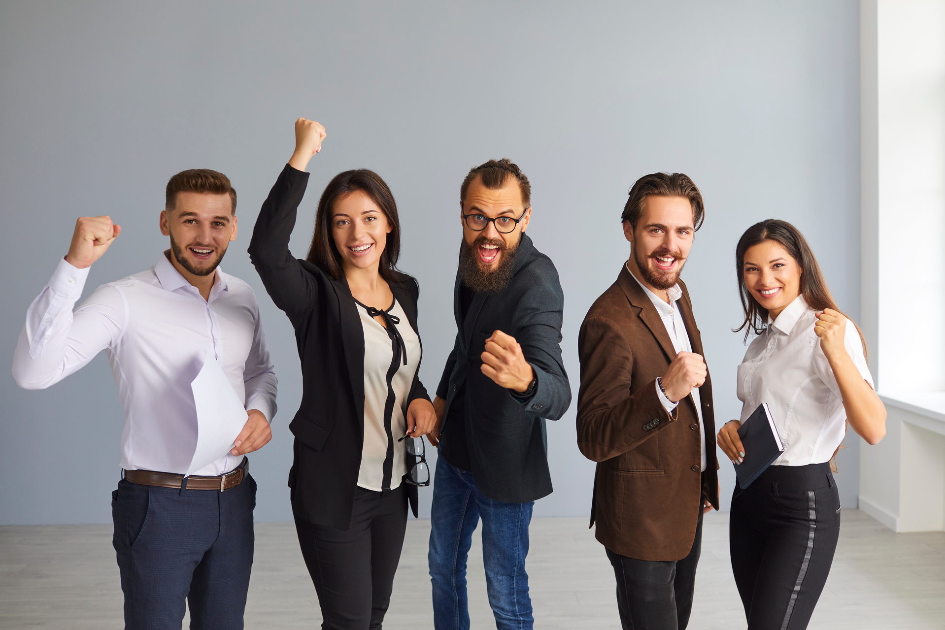 Group of Happy Confident Young Entrepreneurs Celebrating Their Professional Success